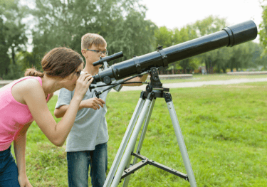 Kids using telescope