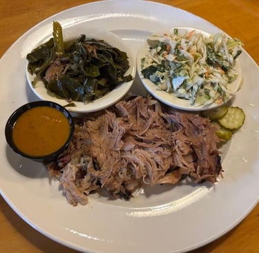 Carolina Pork Plate with Mustard Base BBQ sauce. Collard greens and cole slaw served on the side.