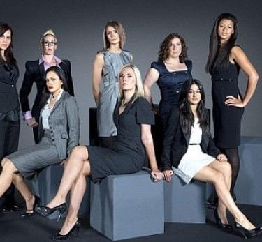 a group of women in business attire posing for a picture