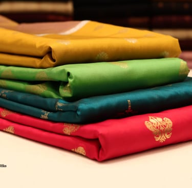 a stack of folded folded folded fabric with a gold leaf design