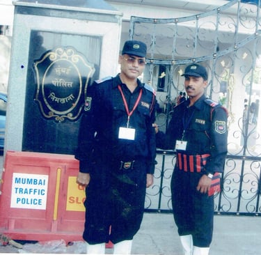 two men in uniform uniforms standing in front of a gate