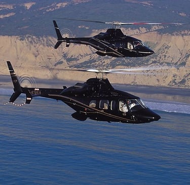 Two AW109 helicopters in flight, showcasing precision engineering and operational reliability.