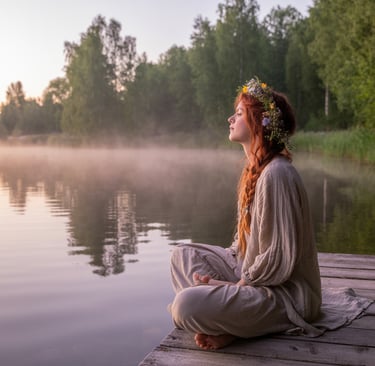 a woman sitting on a dock with a flower crown