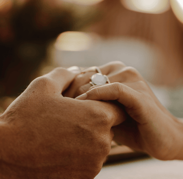 Couple holding hands for emotional support after miscarriage