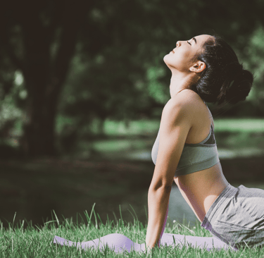 Woman practicing yoga for stress relief and fertility wellness