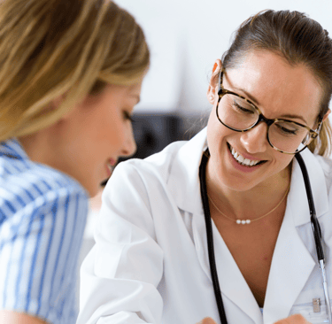 Female doctor warmly explaining fertility results to a patient