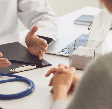 Fertility doctor explaining IVF process to patient during a clinic visit