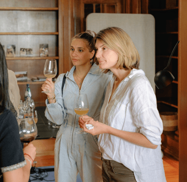 Fertie community members sharing a drink and stories during a relaxed event gathering.