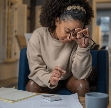 Woman calculating fertility treatment costs at home