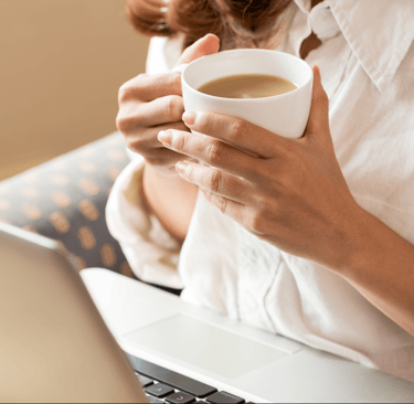 Woman drinking tea while researching fertility online