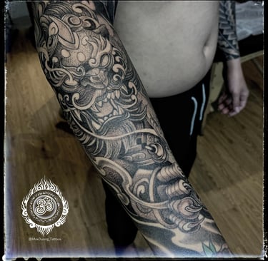 Full sleeve dotwork and Asian-style Foo Dog tattoo on the forearm