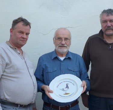 three men standing next to each other holding plates