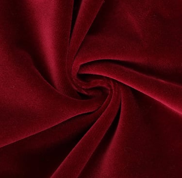 a red velvet fabric with a large, circular shaped object