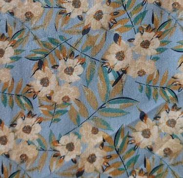 a blue floral print fabric with a bird on it