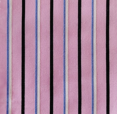 a pink shirt with a black and white striped tie