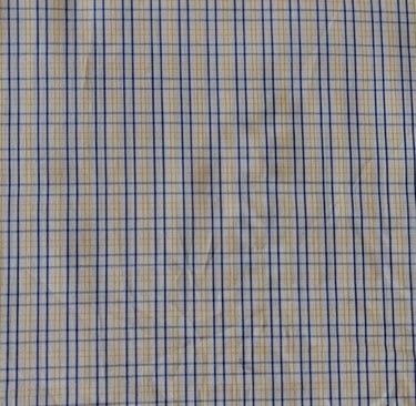 a close up of a shirt with a blue and yellow checkered pattern