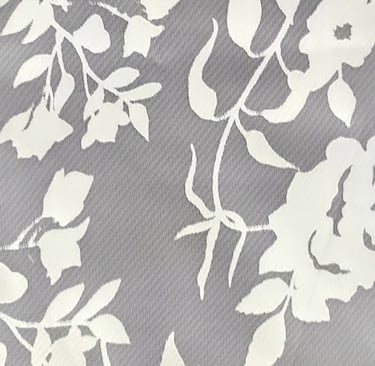 a close up of a white and grey floral print fabric