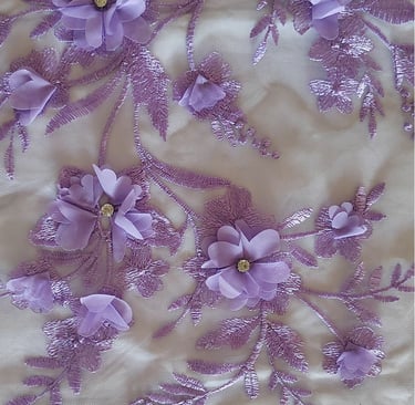 a close up of a purple and white floraled fabric
