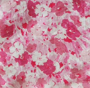 a pink and white floral print fabric with a pink flower