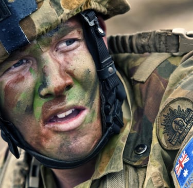 a soldier's face is covered in camouflage