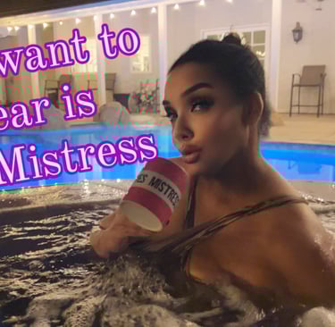 MsMadyson in a chocolate swimsuit in a hot tube at night holding a pink cup that says Yes Mistress