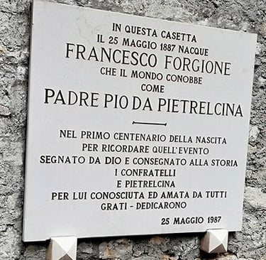 Plaque on wall featuring Padre Pio