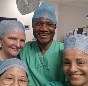 Mr Onwudike (centre) in surgical scrubs, surrounded by his medical team in a selfie