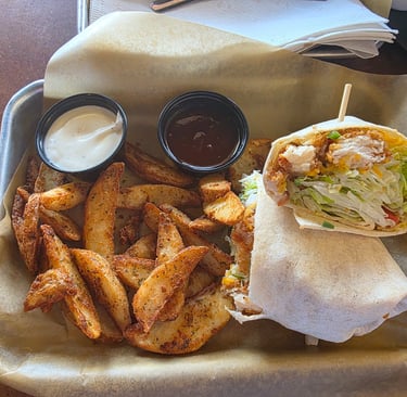 buffalo ranch chicken wrap with potato wedges., a side of ranch and honey bbq sauce from Bdubs
