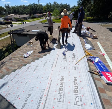 a group of men standing on a roof with a roof that has been painted white