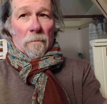 a man with a beard and a scarf around his neck