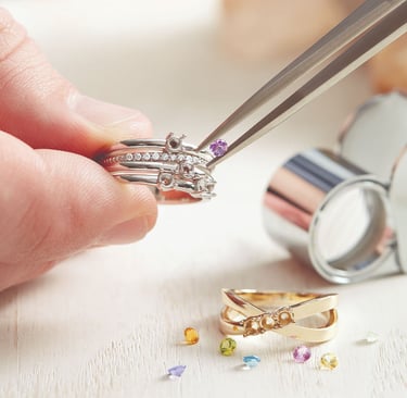 a person holding a pair of rings and a pair of scissors