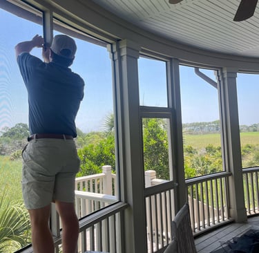 Technician installing screen on a back porch.