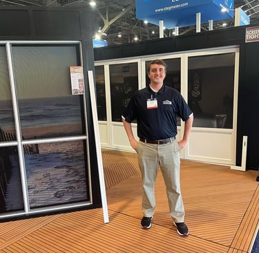 Representative showcasing screen porch solutions at a trade show booth.