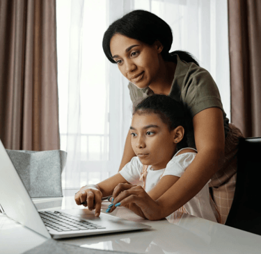 A mother helps her daughter.