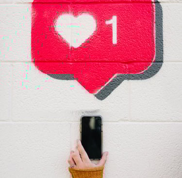 a person holding a cell phone up to a wall