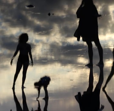 a group of people walking on a beach