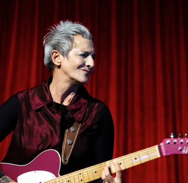 a woman with a guitar and a guitar