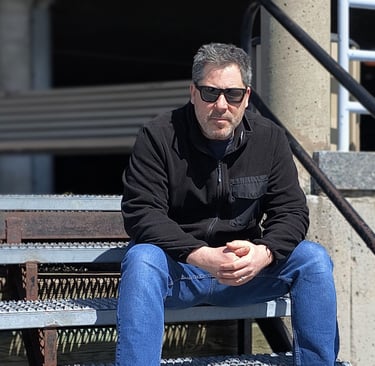 a man sitting on a bench in a stadium