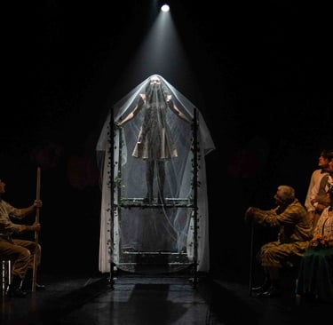 a man in a white dress standing in front of a stage set