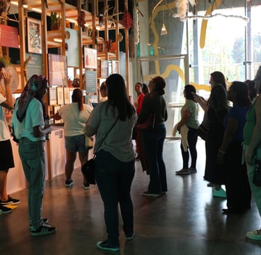 a group of people standing around a display case