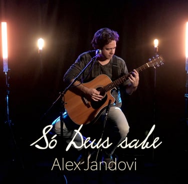 a man playing guitar and singing into a microphone