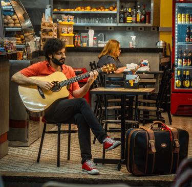 a man playing guitar in a restaurant