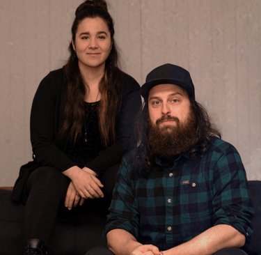 a man and woman sitting on a couch