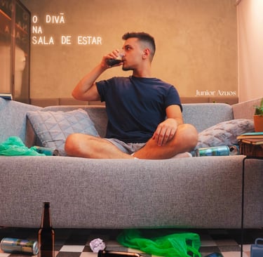 a man sitting on a couch drinking a beer