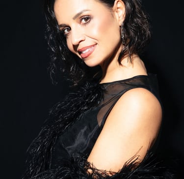 a woman in a black dress with a black feathered jacket