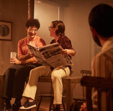 a man and woman sitting on a bench in a room