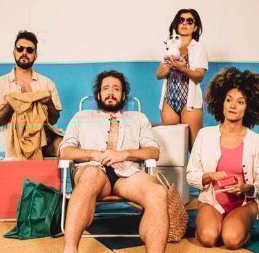 a group of people sitting on a beach