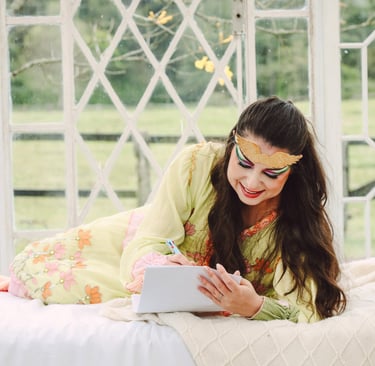a woman in a green dress is laying on a bed