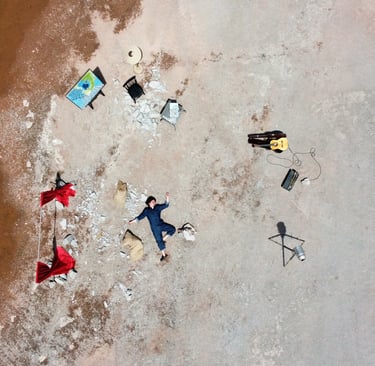 a person laying on a beach with a surfboard