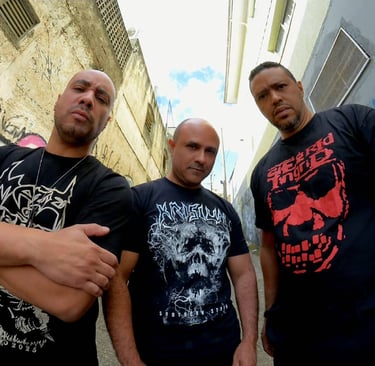 three men standing in a alleyway with graffiti on the wall